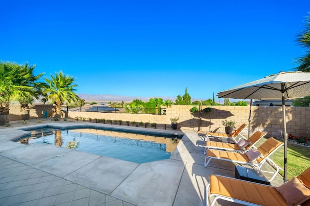 view of pool featuring a mountain view and a patio area