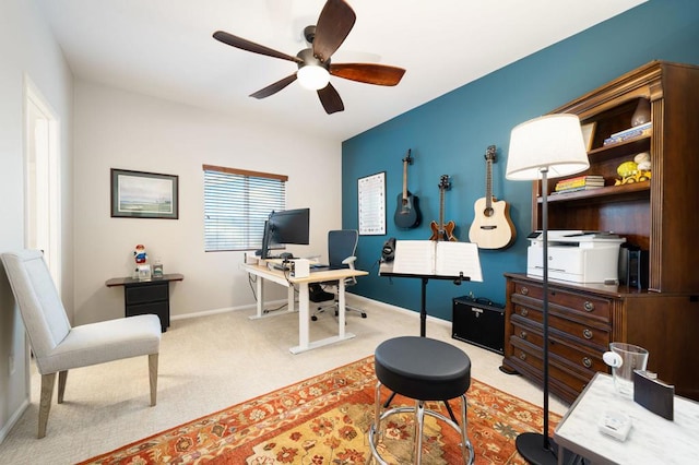 home office with light carpet and ceiling fan