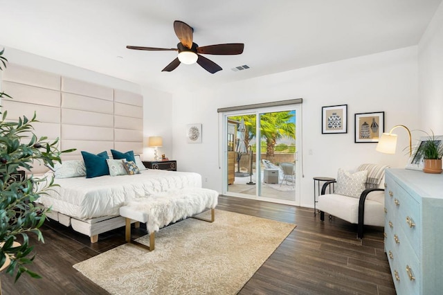 bedroom with access to exterior, dark hardwood / wood-style floors, and ceiling fan