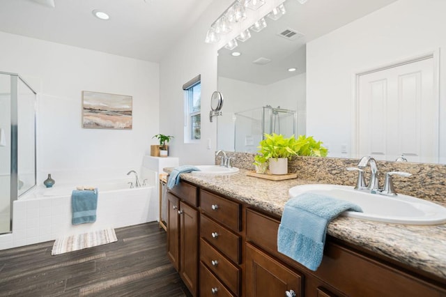 bathroom featuring separate shower and tub, hardwood / wood-style floors, and vanity