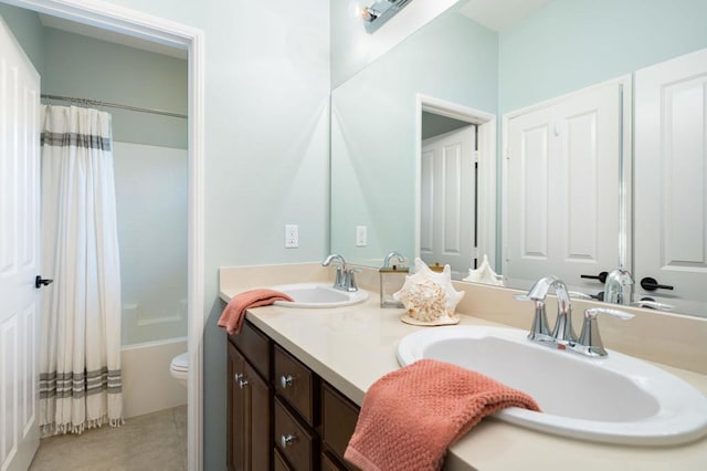 full bathroom with tile patterned flooring, shower / tub combo, vanity, and toilet