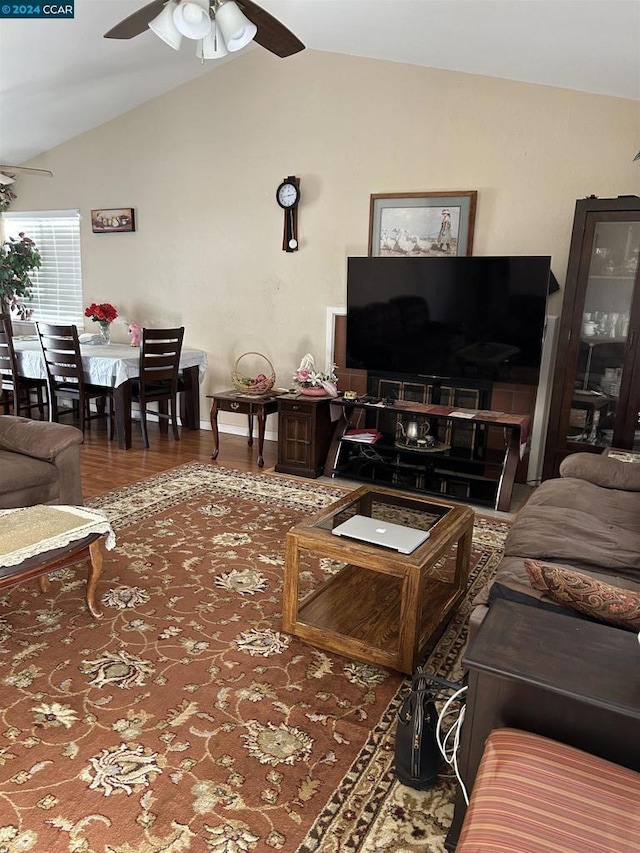 living room with lofted ceiling, ceiling fan, and hardwood / wood-style flooring