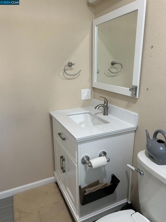 bathroom featuring toilet and vanity