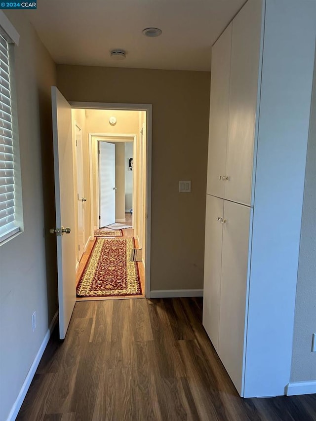 corridor featuring dark hardwood / wood-style floors