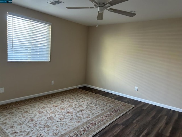 spare room featuring ceiling fan and dark hardwood / wood-style floors