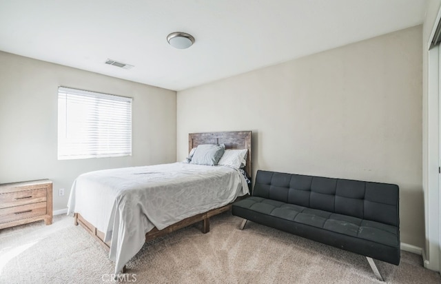 bedroom featuring light carpet