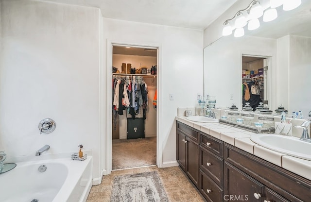 bathroom featuring vanity and a bath