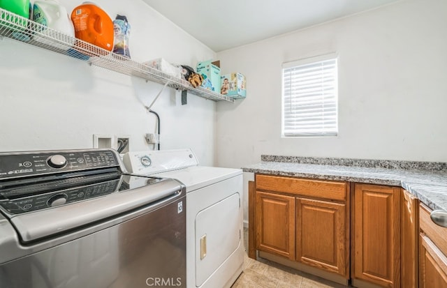 laundry area with cabinets and separate washer and dryer