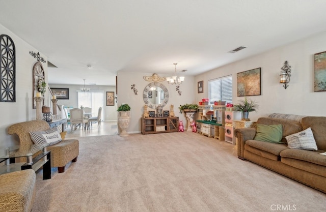 carpeted living room featuring a notable chandelier