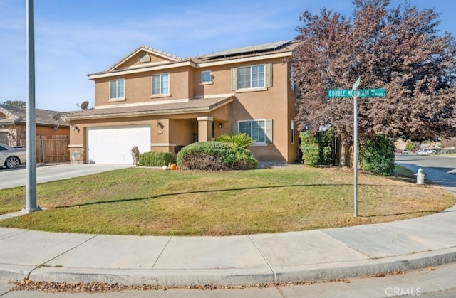 view of front of house featuring a garage and a front lawn