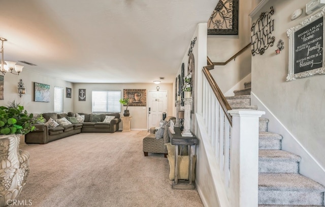 living room featuring carpet floors and an inviting chandelier