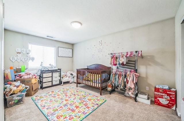 bedroom with carpet floors and a crib