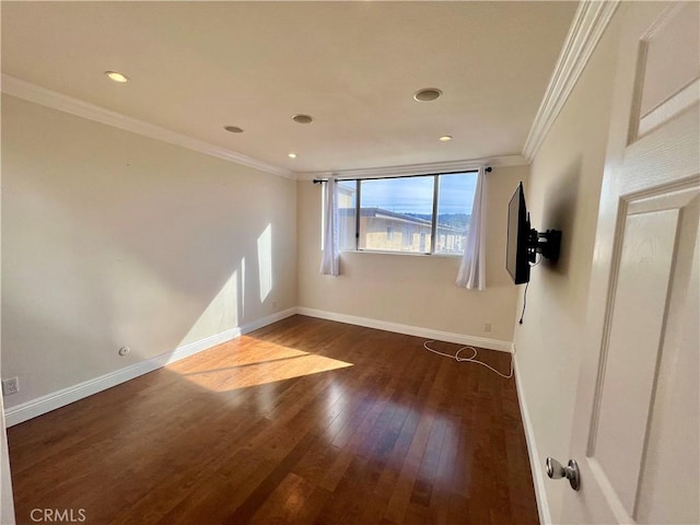 spare room featuring dark hardwood / wood-style flooring and ornamental molding