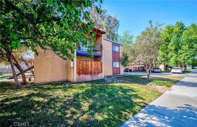 view of property exterior with a yard