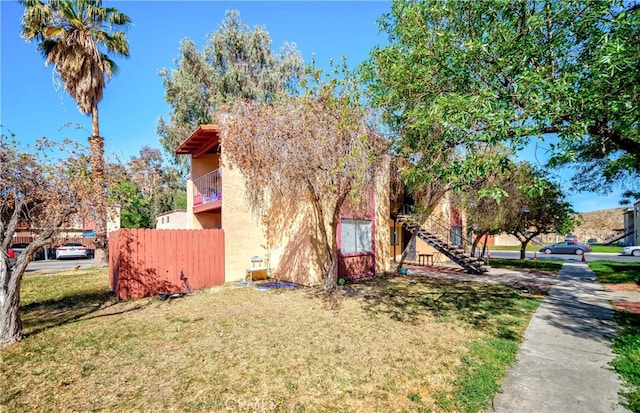 view of side of property with a lawn