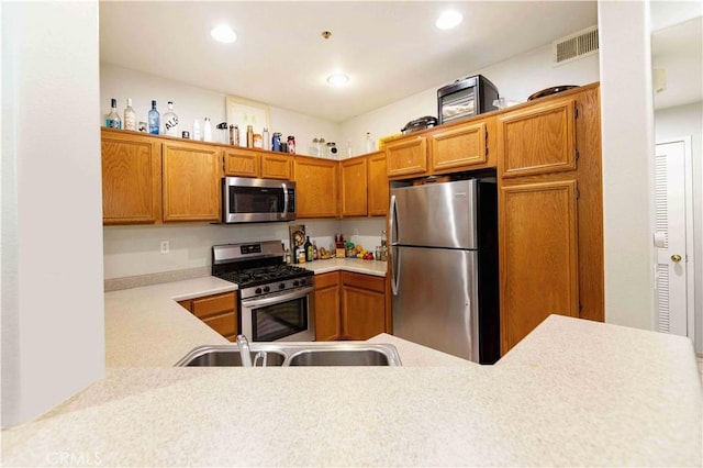 kitchen with sink, kitchen peninsula, and stainless steel appliances