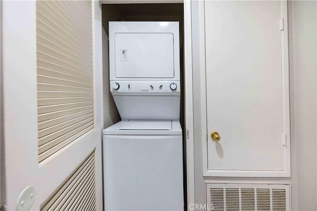 laundry area featuring stacked washer and dryer