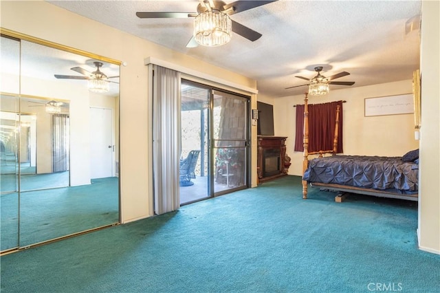 bedroom with access to outside, ceiling fan, carpet floors, and a textured ceiling