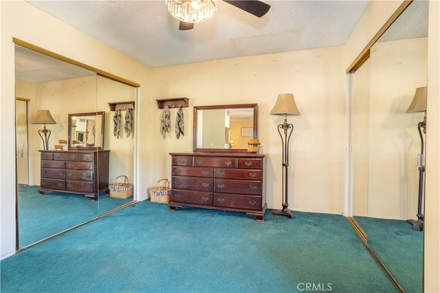 interior space with carpet, ceiling fan, and a textured ceiling