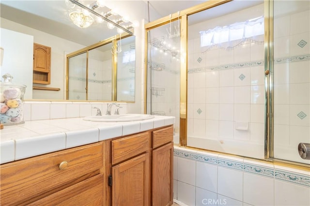 bathroom featuring vanity and enclosed tub / shower combo