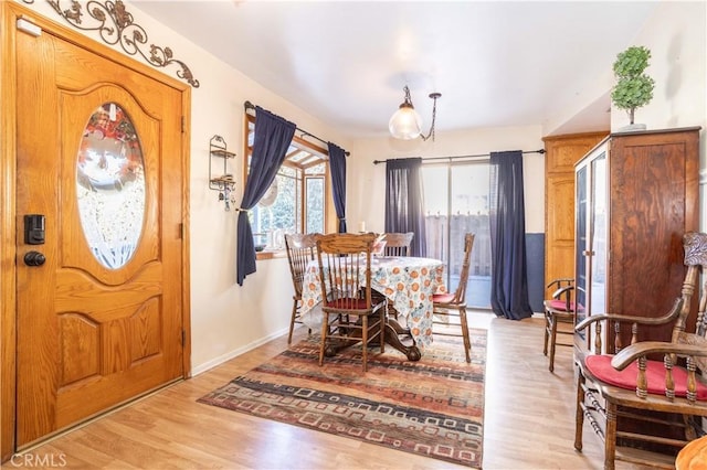 dining space with light hardwood / wood-style floors