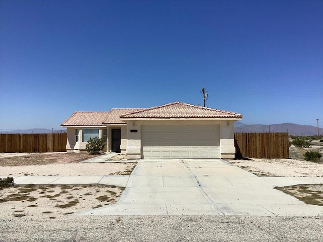 view of front of home featuring a mountain view and a garage