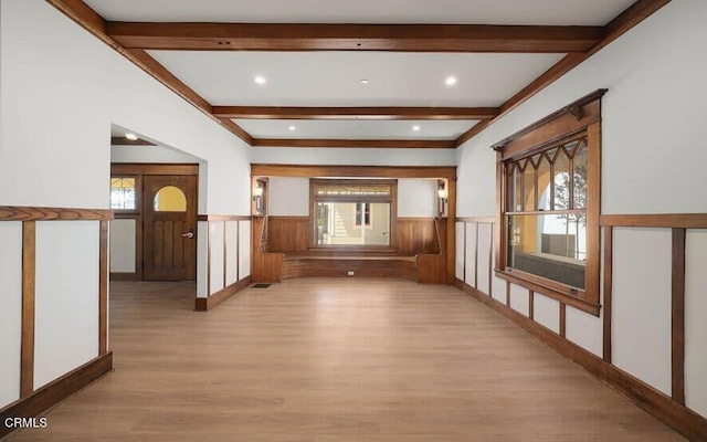 hall with beam ceiling and light hardwood / wood-style flooring