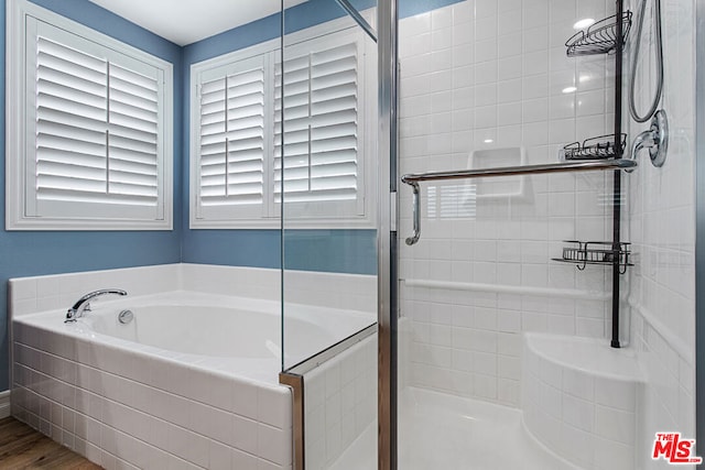 bathroom featuring hardwood / wood-style flooring and independent shower and bath