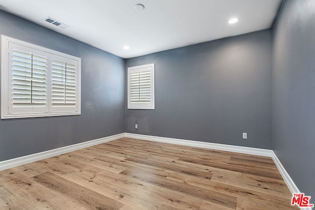 unfurnished room with light hardwood / wood-style flooring