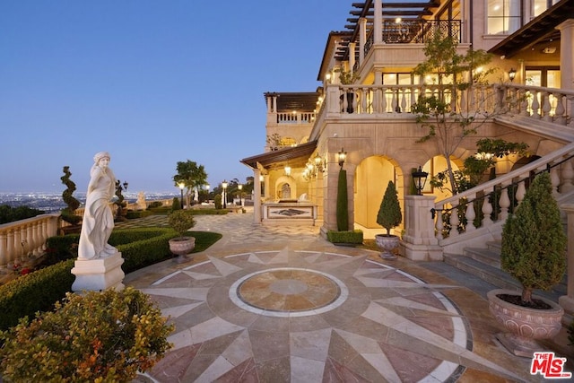 patio terrace at dusk with a balcony