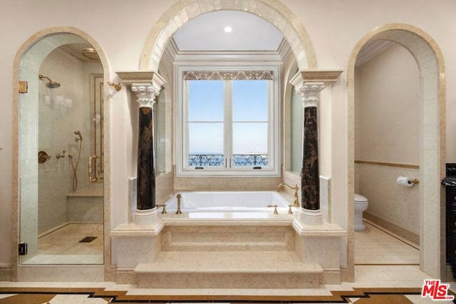 bathroom featuring separate shower and tub, ornate columns, toilet, and tile patterned floors