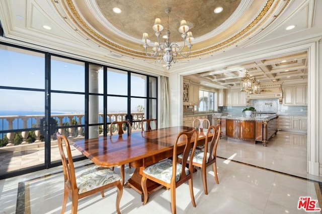 tiled dining area with ornamental molding, plenty of natural light, and a raised ceiling