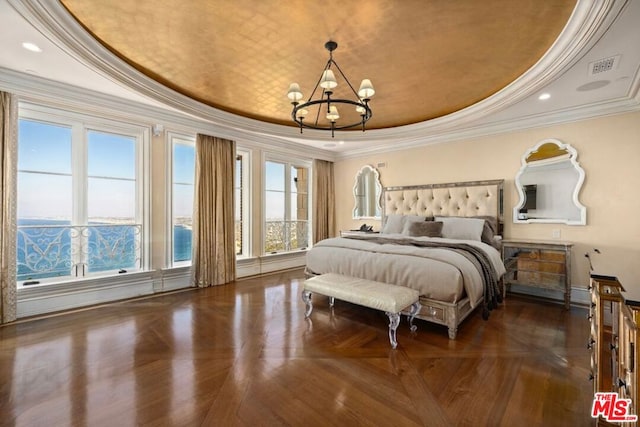 bedroom featuring ornamental molding, dark parquet flooring, and a raised ceiling