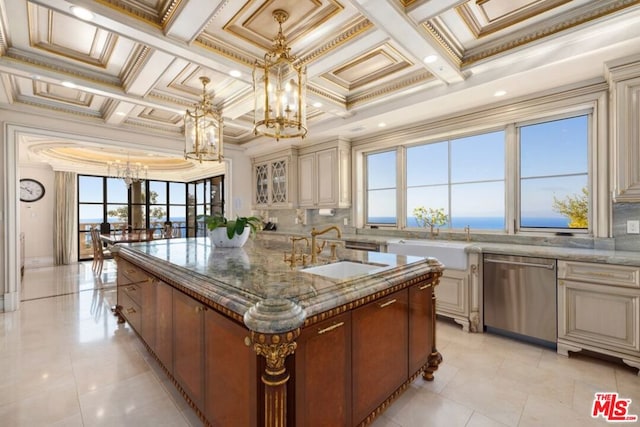 kitchen with crown molding, stainless steel dishwasher, a center island with sink, and plenty of natural light