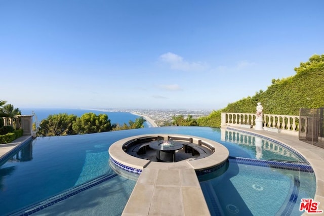 view of pool featuring a water view