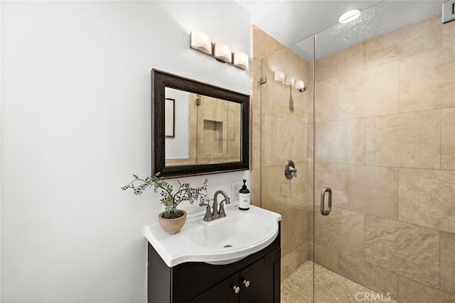 bathroom with vanity and a shower with door