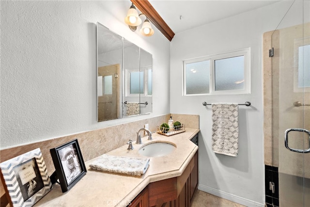 bathroom featuring an enclosed shower and vanity