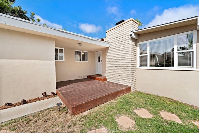 entrance to property featuring a deck