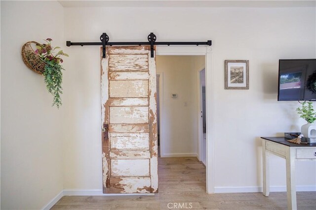 interior space featuring hardwood / wood-style flooring and a barn door