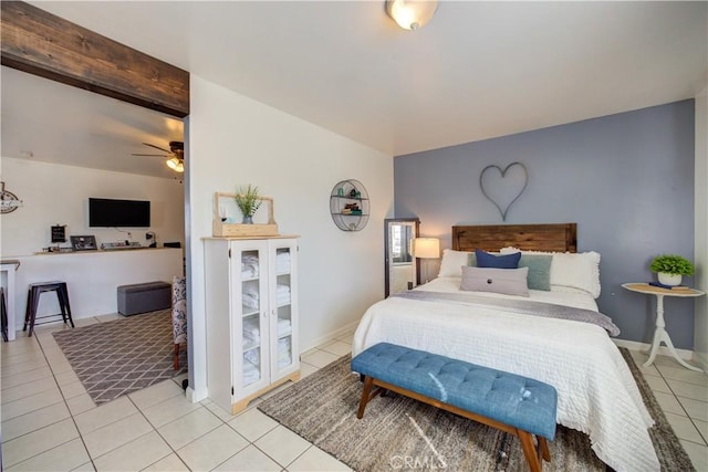 bedroom featuring light tile patterned floors and beamed ceiling