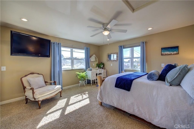 bedroom featuring light carpet, multiple windows, and ceiling fan