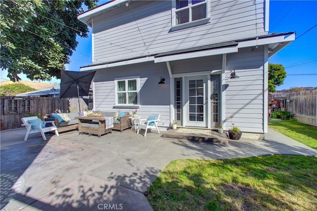 rear view of house featuring outdoor lounge area and a patio