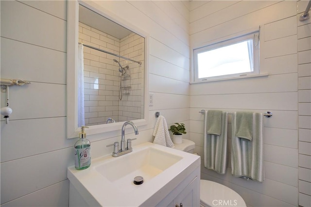 bathroom featuring vanity, toilet, and curtained shower