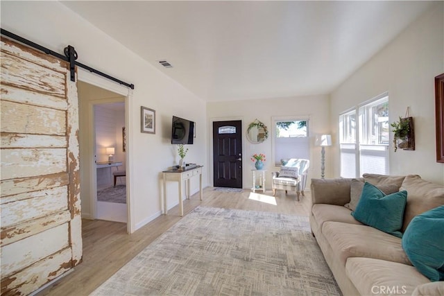 living room featuring light hardwood / wood-style flooring and a barn door