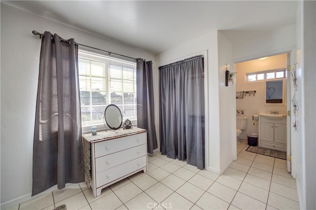 interior space with vanity, toilet, and tile patterned flooring