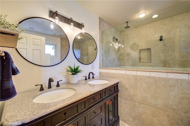 bathroom featuring vanity and a tile shower