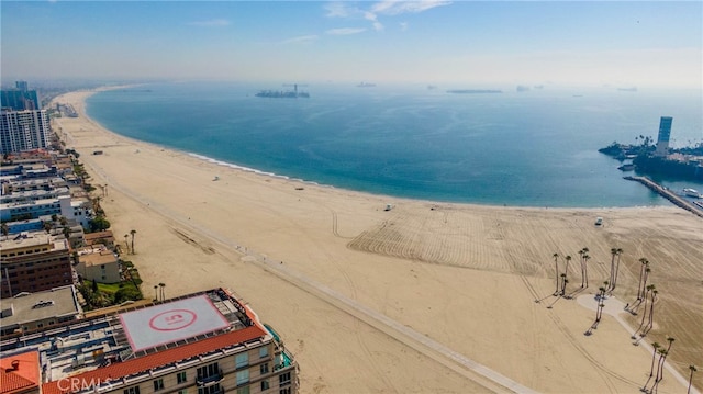 drone / aerial view featuring a water view and a beach view