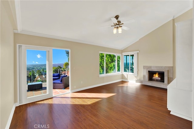 unfurnished living room featuring lofted ceiling, wood finished floors, and a wealth of natural light