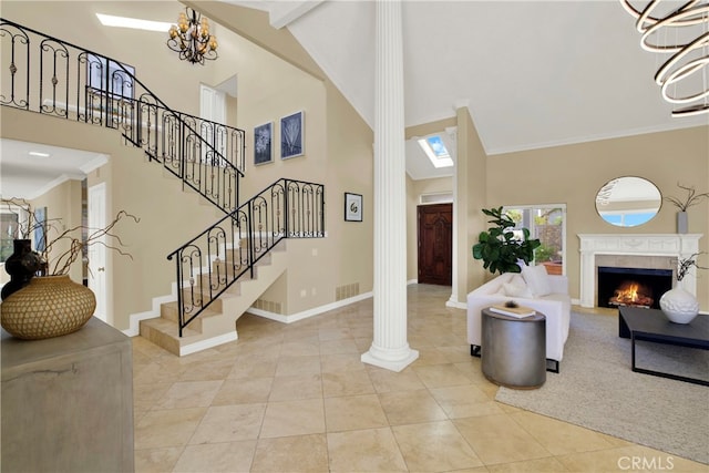 entrance foyer with a fireplace, visible vents, baseboards, ornamental molding, and stairway