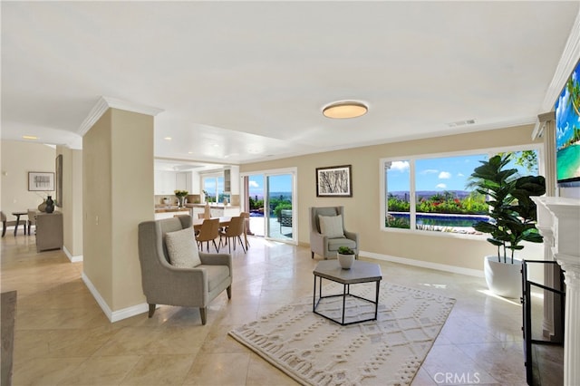 living area featuring plenty of natural light, a fireplace, visible vents, and baseboards